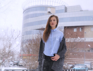 Young girl outdoors in winter. Model girl posing outdoors on a winter day. A festive weekend in the street walking girl.