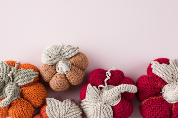 Collection of toy pumpkins on light pink background