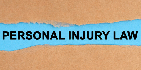 The paper is ripped in the middle. Inside on a blue background it is written - Personal Injury Law