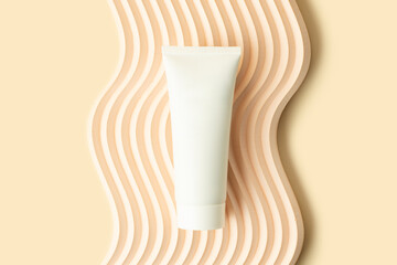 Blank white cosmetics tube on the beige background.Wavy podium under it.Good as cosmetic...
