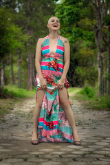 Portrait Beautiful and strong woman fighting breast cancer Smiling and a lot of happiness. Hairless and bald. Willingness to live and joy to fight. Laugh on the road in sensual dress.