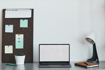 Clean background image of minimal home office workplace with laptop and accessories in black and white, copy space
