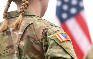 American Soldiers looks on the US flag. US Army. Military forces of the United States of America....
