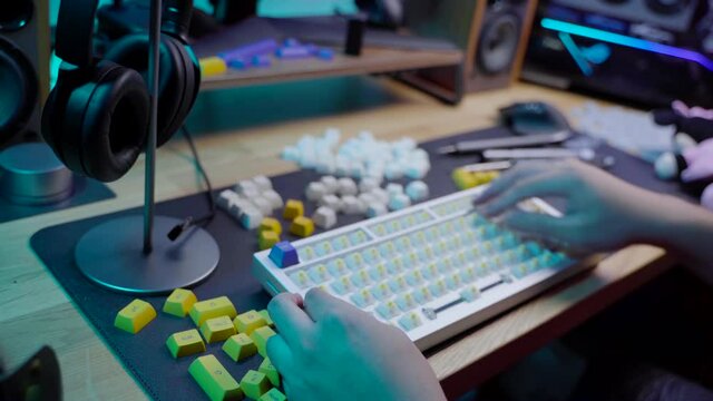 A footage of a man assemble a DIY premium custom keyboard build kit with full alluminium base and bright RGB LED Colors
