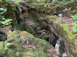 Stones overgrown with tufa and moss in the stream bed under the Zagorska pec cave in the village of...