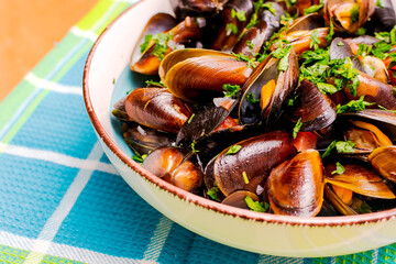 Boiled mussels with lemon and parsley in a plate