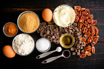 Ingredients for Brown Butter Bourbon Pecan Chocolate Chunk Blondies: Chocolate chunks, pecan halves, and other raw ingredients for blondies