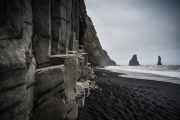 The famous Reyinisfjara black volcanic sand beach with its basalt columns an sea stacks , South...