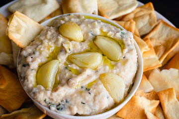Roasted Garlic and Rosemary White Bean Dip: Dip made from cannellini beans, olive oil, and roasted garlic served with pita chips