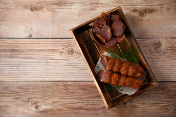 Homemade jerked dried meat or biltong with spices on a wooden background. Beer snack concept....