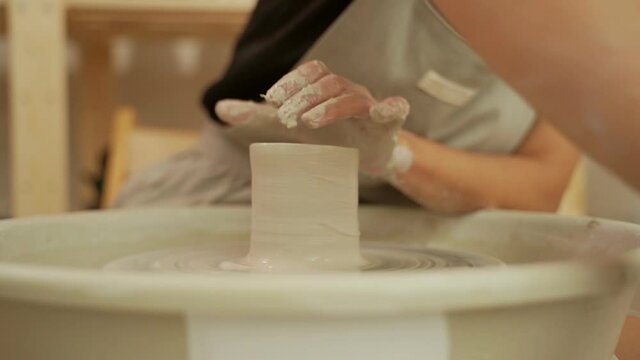 Master crafting pottery in workshop