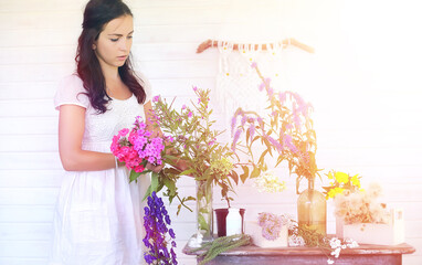 A young girl with a daughter is picking up a bouquet. A young mother with her daughter makes a...