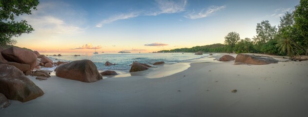 sunset at tropical beach anse lazio on praslin, seychelles