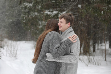 pair of lovers on a date winter afternoon in a snow blizzard