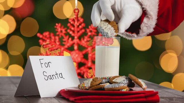 Animation of santa claus picking cookies over orange spots of light