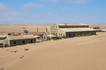 Abandoned buildings in Kolmanskop ghost town in Namib desert, Namibia, Africa.