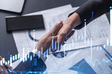 A handshake symbolize a capital market transaction to proceed profit in stock trading. Financial...