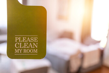 Please make up my room. Maid cleaning the room with please make up my room sign on the door. Opened door of hotel room in morning.Hotel, door open. Clean and elegant accommodation service.