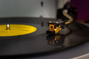 Vintage turntable vinyl record player. Close-up of needle on vinyl record. Selective focus, blurred background