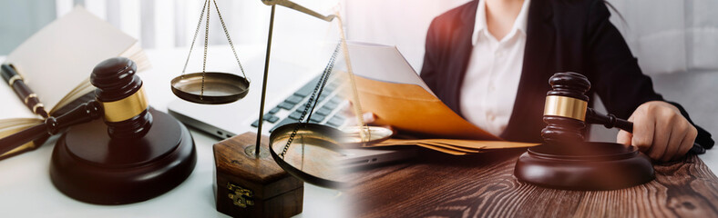 Justice and law concept.Male judge in a courtroom with the gavel, working with, computer and docking keyboard, eyeglasses, on table in morning light © ARMMY PICCA