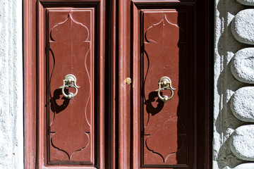 door knocker on the entrance of a house, old ornate metal door handle