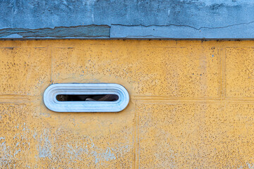 detail of an old letterbox on a brick wall, vintage marble built-in mailbox, Italy, Europe