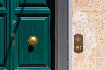 ancient Italian door knob on wooden door