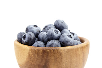 Blueberry in wooden bowl isolated on white background