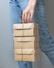 woman holding kraft cardboard boxes, food or clothing delivery, modern ways to buy food with...