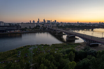 Fototapeta na wymiar wieżowce w cetrum Warszawy, rzeka Wisła, plaża o zachodzie słońca z lotu ptaka, dron
