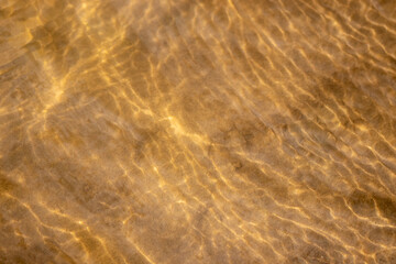Ripples in the water. sandy bottom of the river.