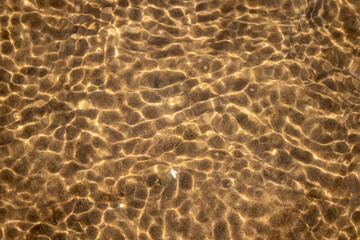 Ripples in the water. sandy bottom of the river.