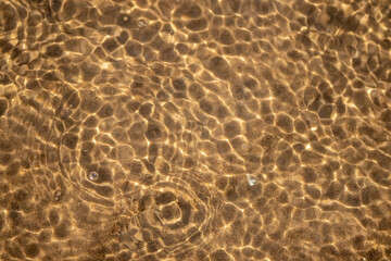 Ripples in the water. sandy bottom of the river.