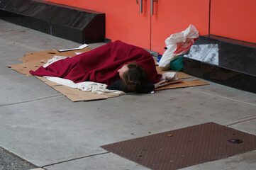 Homeless man sleeping on a street. Vancouver, Canada.