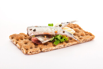 Crispbread with anchovies, spices, butter and parsley