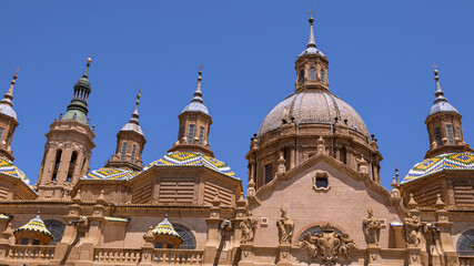 Obraz premium Cityscape view on the roofs and spires of basilica of Our Lady in Zaragoza city.