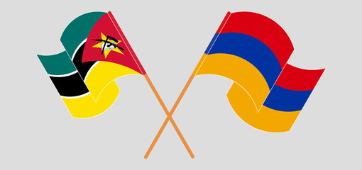 Crossed and waving flags of Mozambique and Armenia