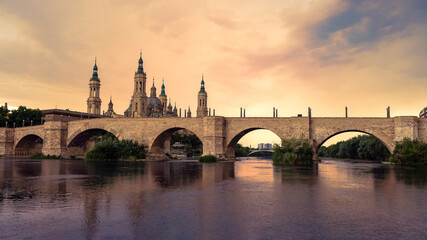 Fototapeta na wymiar Cathedral Basilica of Our Lady of Pillar with bridge and Ebro river at Zaragoza