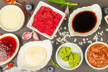Set of different sauces - ketchup, mayonnaise, barbecue, soy, chutney, wasabi, adjika, horseradish