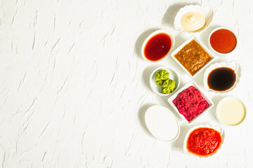 Set of different sauces - ketchup, mayonnaise, barbecue, soy, chutney, wasabi, adjika, horseradish