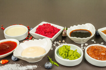 Set of different sauces - ketchup, mayonnaise, barbecue, soy, chutney, wasabi, adjika, horseradish
