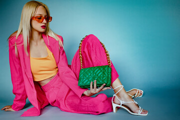 Fashion portrait of woman wearing trendy fuchsia suit, orange sunglasses, top, strappy sandals,...