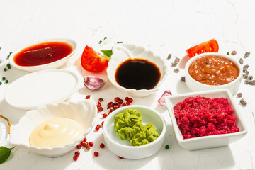 Set of different sauces - ketchup, mayonnaise, barbecue, soy, chutney, wasabi, adjika, horseradish
