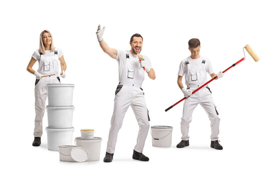 Team of painters dancing and playing with paint rollers and buckets