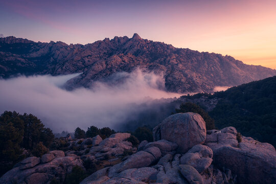 Fog between ridges and boulders at dawn