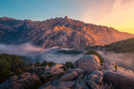 Fog between ridges and boulders at dawn