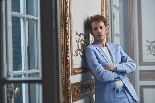 Pensive man in suit in luxury room