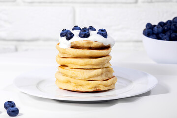 Blueberry Pancakes With Yoghurt on white background, Traditional American Healthy Breakfast, Copyspace, Horizontal Resolution