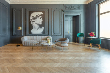 chic interior of the room in the Renaissance style of the 19th century with modern luxury furniture. walls of noble dark color are decorated with stucco and gilded frames, wooden parquet.