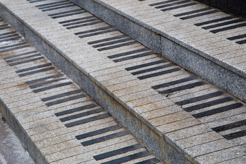 public granite stairs stylized as piano keys - close-up view